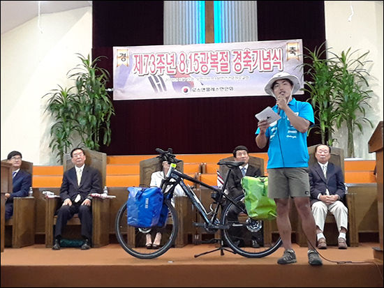 독도가 우리땅이라는 것을 알리기 위해 미서부 종단길에 나선 대학생이 자전거를 단상에 올리고 독도의 중요성을 이야기하고 있는 하우영 중앙대 학생