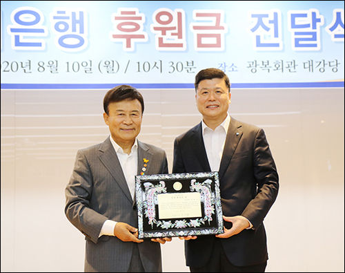 김원웅 광복회장(왼쪽)이 권광석 우리은행장에게 경주 최부자상을 줬다.