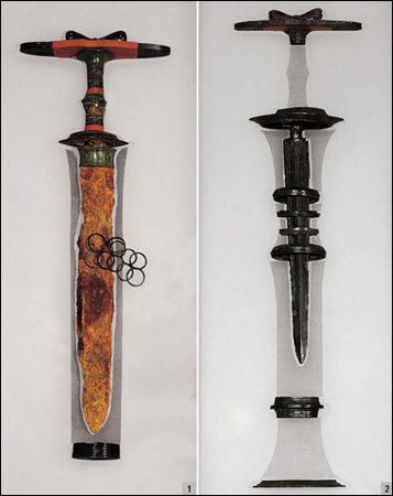 청동장식손잡이 철검과 동검, 2세기 전후, 사라2093(좌) 2087(우), 길이 46.7cm(좌) 43.8cm(우)<br>
1 청동장식손잡이 철검(결합형A) / 2 청동장식손잡이 동검(결합형B)<br>
청동장식손잡이 철검은 주인공의 허리 부근에 둔 것으로, 손잡이는 흑칠한 나무 몸체에 청동 장식을 덧씌워서 만들었습니다.