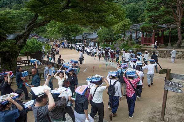 1년동안 정성으로 사경한 사경집을 머리에 이고 소전대로 향하는 신도들