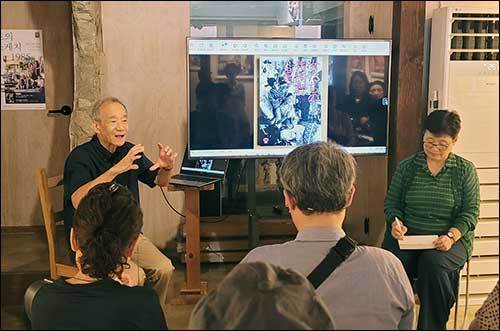 화면을 넘겨가며 사진의 배경 설명을 하는 오오타 준이치 작가(왼쪽), 통역을 맡은 도다 이쿠코 관장 